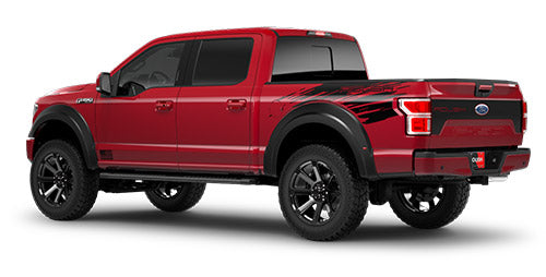 A red pickup truck with black decals on the side and rear, featuring large wheels and a crew cab configuration, is equipped with all-terrain tires to tackle any landscape.