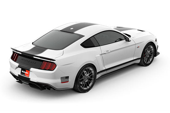 A sleek white sports car with a black roof, black accents, and a 5.0L V8 engine roars into view from a rear side angle. Its Mustang charm is enhanced by a spoiler and dual exhausts, hinting at the power of the ROUSH Stage 2 upgrade.