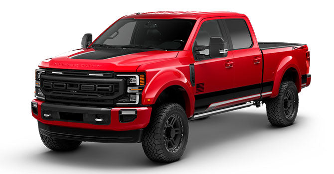 Red and black ROUSH Super Duty pickup truck with a large grille, black wheels, all-terrain tires, and side steps, shown from a front-side angle.