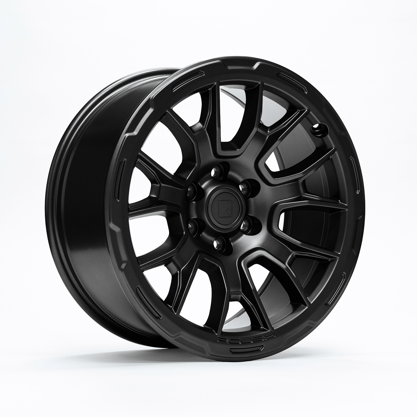 A Roush F-150 wheel in matte black showcases its stunning multi-spoke design against a plain white background, embodying sleek sophistication.