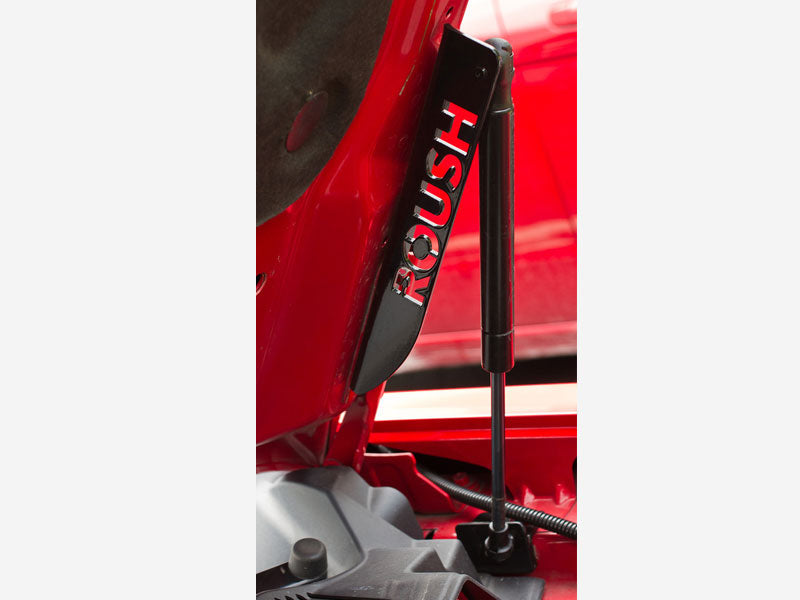 Close-up of a heavy-duty gas strut branded with the word "ROUSH," designed specifically for 2005-2014 Mustang models.