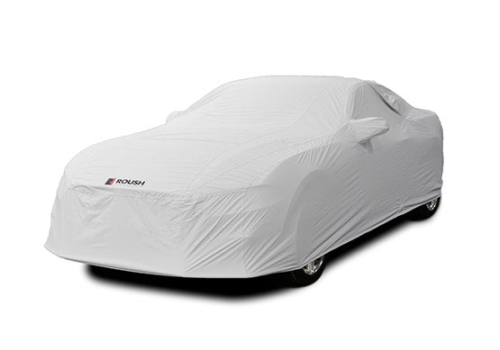 A Roush Mustang car cover made from water-resistant fabric fully envelops the car, showcasing a prominent logo on the front.