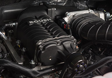 Close-up of a Roush supercharger in an engine bay, part of the Phase 2 Upgrade Kit, boosting the Roush F-150 to an impressive 650 HP.