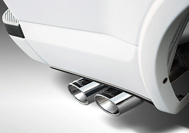 A close-up view of a car's Roush Cat-Back Exhaust pipes, showcasing the gleaming metallic design against the vehicle's white exterior.