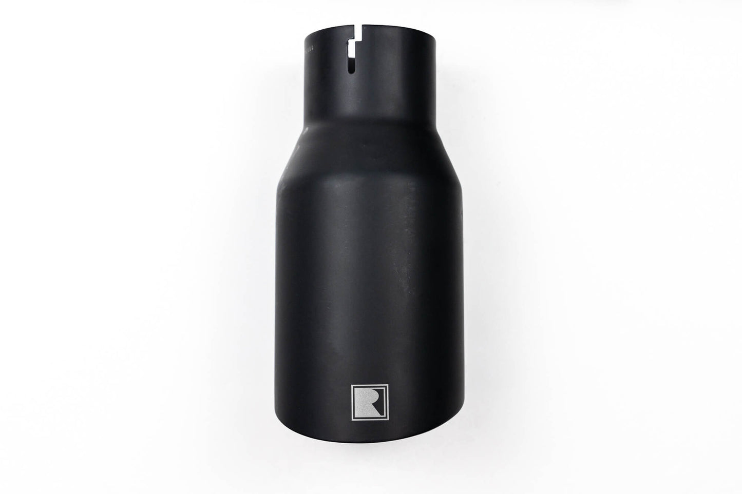 A sleek black cylindrical object with a matte finish and a small rectangular logo near the bottom, reminiscent of the Roush Bronco Axle-Back Exhaust designed for 2021-2024 Ford Broncos.