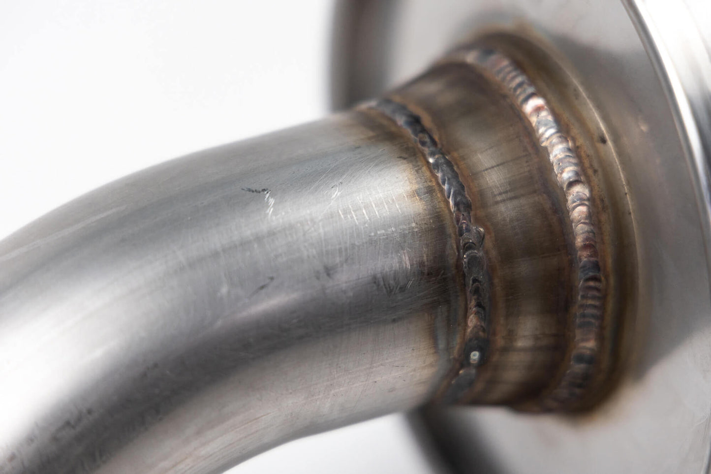 Close-up image of a welded joint on a metal pipe, showcasing detailed weld beads and the aggressive sound of the Roush Bronco Performance Exhaust 2.3 and 2.7 from Roush Performance Products, Inc.
