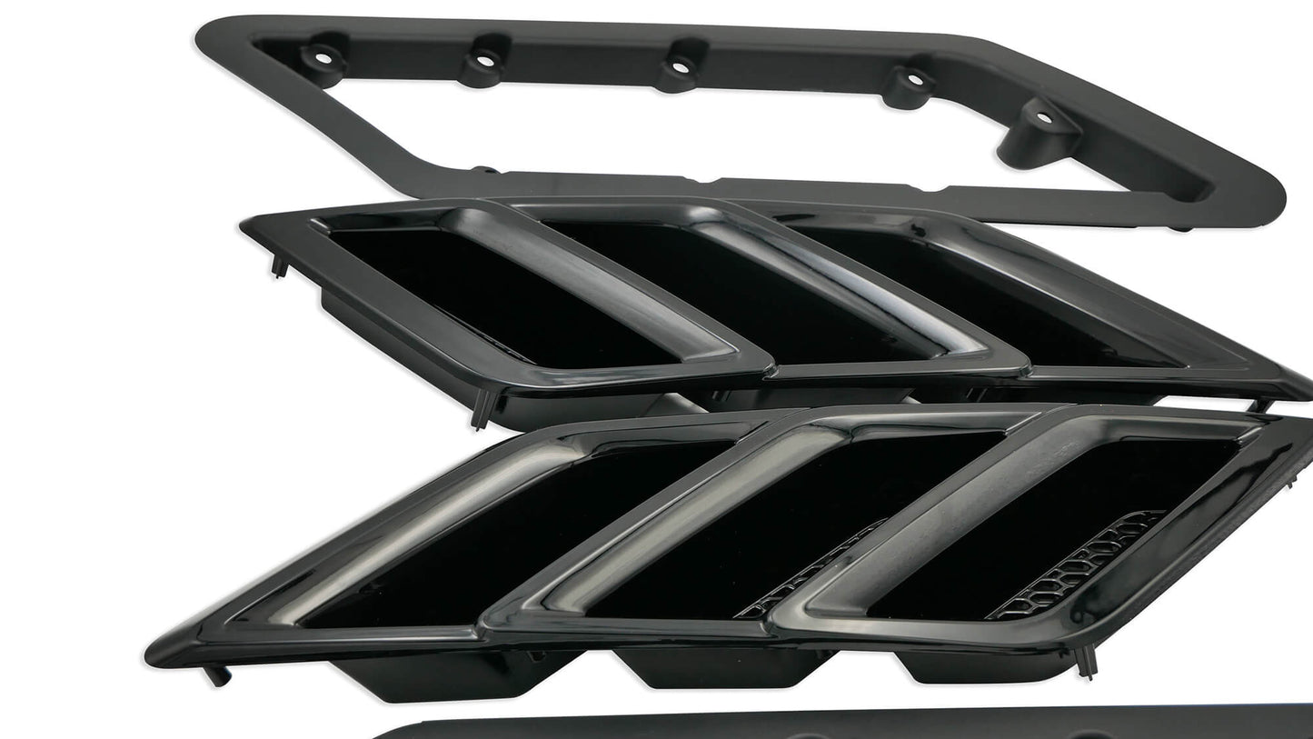 Black automotive air vent components and Fender Vent Heat Extractors arranged on a white background, enhancing both aesthetics and thermal efficiency.