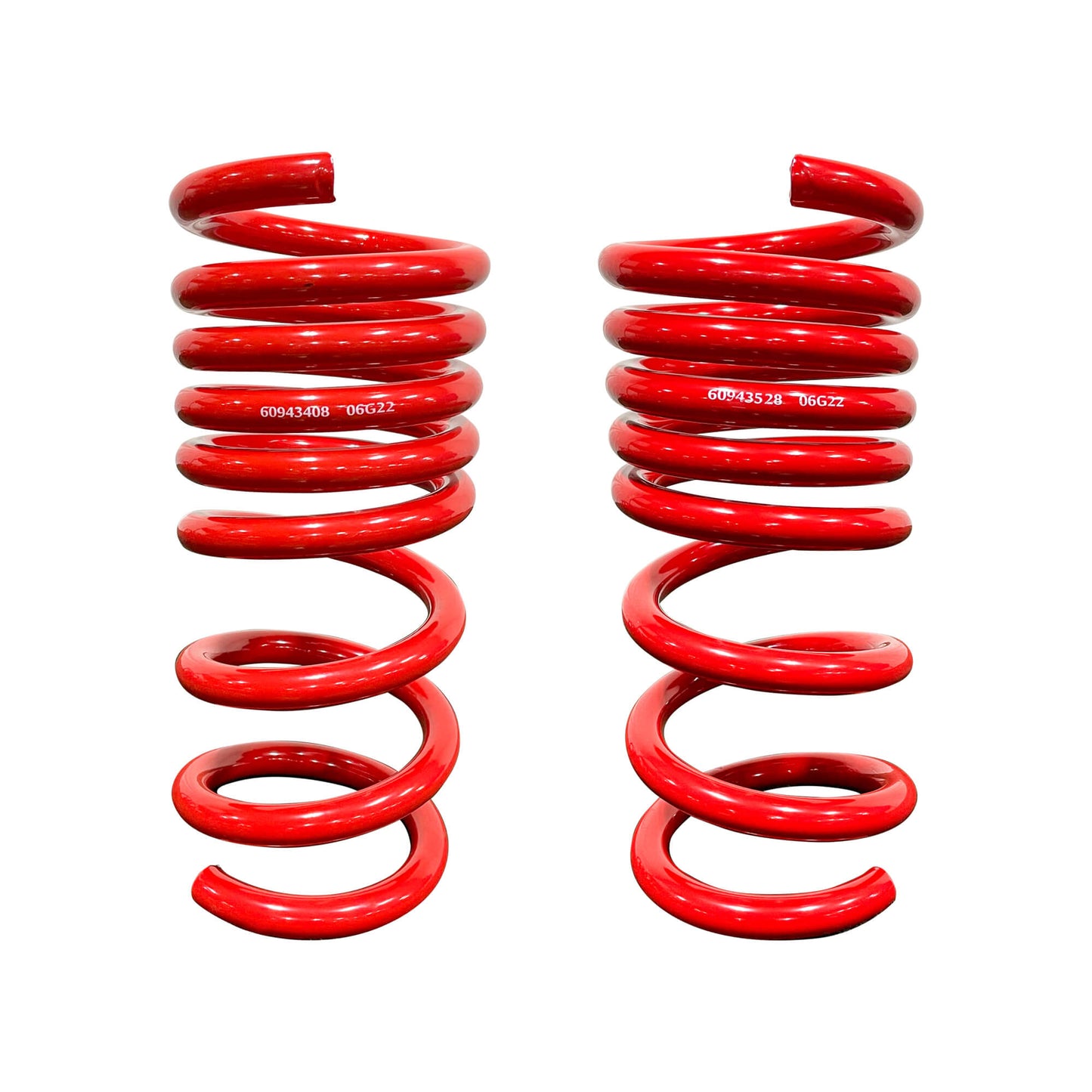 Two red metal coil springs, standing upright against a plain white background. Each spring, designed for the Roush MagneRide Suspension Kit and perfect for lowering Mustangs, has a unique alphanumeric code printed on its side.