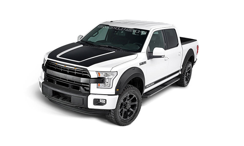 A white pickup truck with black detailing on the hood and roof, boasting ROUSH Performance enhancements for an exhilarating drive.