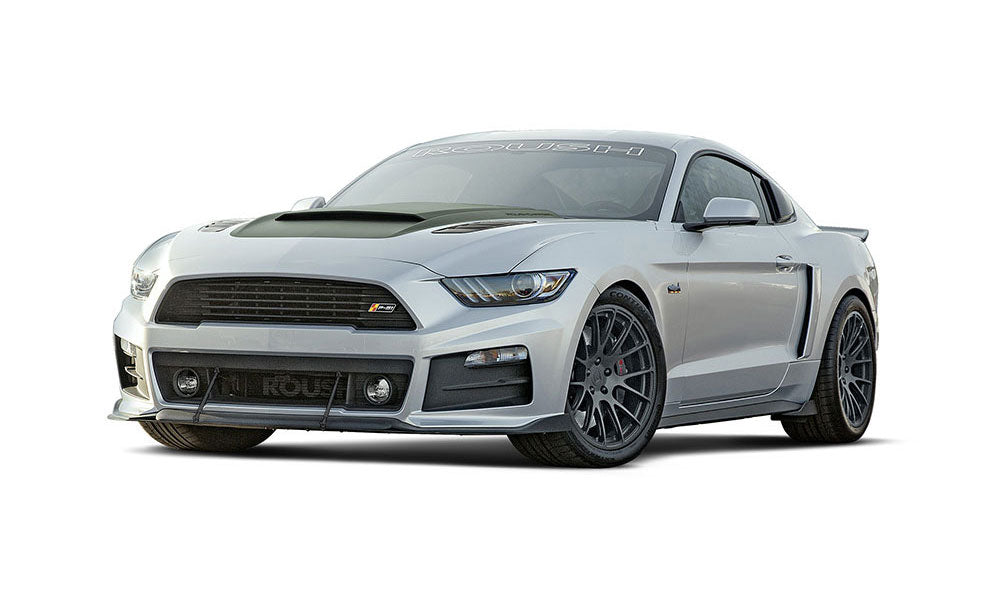 Silver sports car with a sleek design, aggressive front grille, and black alloy wheels, featuring a ROUSH P-51 influence viewed from the front-side angle.