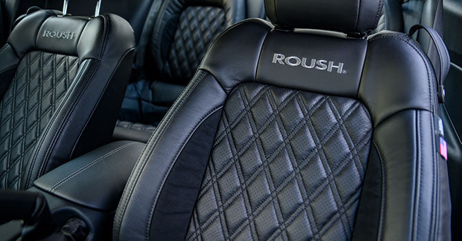 
                  
                    Car seats with diamond-patterned stitching and "ROUSH" branding on the headrests perfectly complement the performance of the ROUSH Stage 3 package, featuring a powerful supercharger for unmatched driving thrills.
                  
                