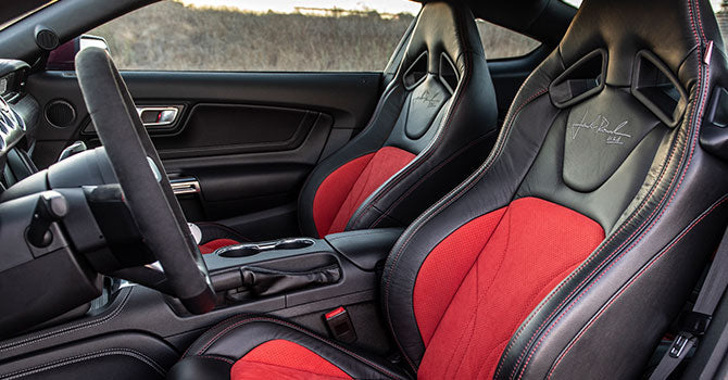 
                  
                    Experience the thrill of the Jack Roush Edition with a car interior that boasts black and red leather seats, a sleek steering wheel, and a center console designed for ultimate control. The ROUSH Mustang's 775HP supercharger awaits, merging power with impeccable style.
                  
                