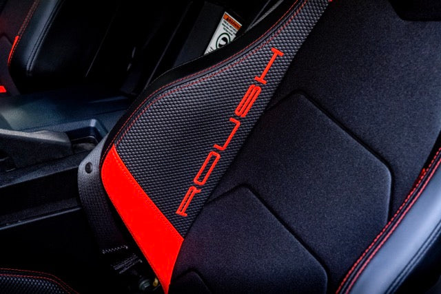 
                  
                    Close-up of a Slingshot Roush Edition car seat with black and red accents, featuring the word "ROUSH" stitched vertically on the side—perfectly capturing racetrack attitude in every detail.
                  
                