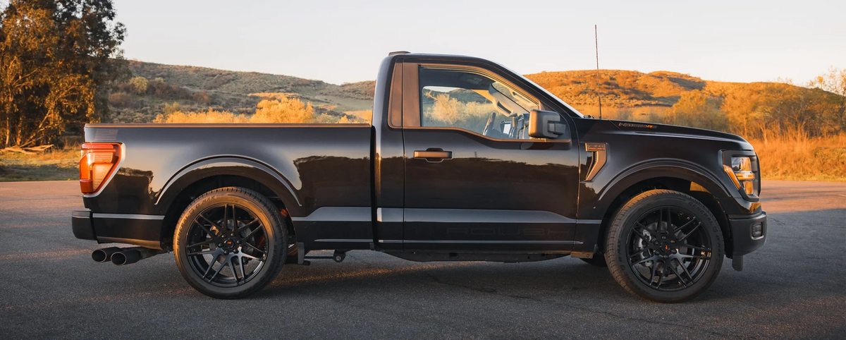 
                  
                    Profile view of a black Roush Nitemare F-150 pickup truck parked on asphalt.
                  
                