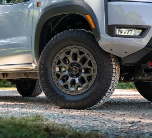 Upgraded 17-inch wheels and 265/70R17 all-terrain tires with black lug nuts and exclusive "R" center caps