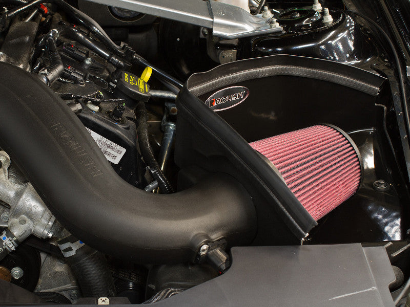 A close-up of a 2011-2014 Roush Mustang Cold Air Intake Kit 3.7L V6 engine compartment highlighting a red air filter inside a black casing with various engine components visible from Roush Performance Products, Inc.