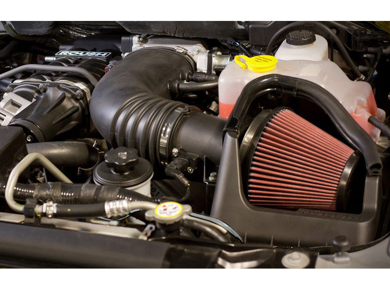 
                  
                    Close-up of a 6.2L engine highlights a high-performance air intake system with a red cone-shaped filter, complemented by the robust Roush R2300 supercharger components, perfect for boosting your Ford F-150's power and efficiency.
                  
                