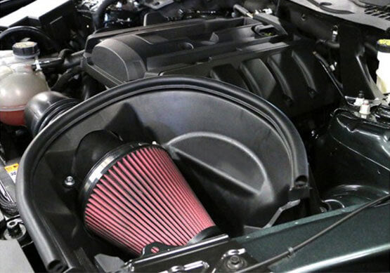 
                  
                    Close-up of a car engine with a prominent red cone air filter in the foreground, showcasing the EcoBoost Cold Air Kit for increased performance.
                  
                