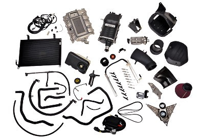 Assorted car engine components, including cables, a radiator, hoses, and various parts spread out on a white background, reminiscent of the high-performance upgrades in Phase 2 727 HP Roush Mustang Supercharger kits.