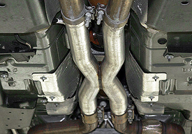 
                  
                    A view of a Roush Mustang GT’s exhaust system from underneath reveals stainless steel pipes and components arranged in an "X" configuration, perfect for those considering a resonator delete X-pipe upgrade.
                  
                