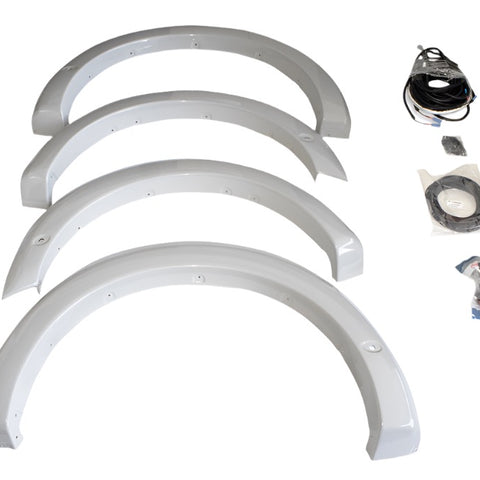 Four primed fender flares are arranged in a row, accompanied by cables and accessories on the right side. Perfect for those seeking a sleek upgrade, this F-150 fender flare kit brings both style and functionality to your vehicle.
