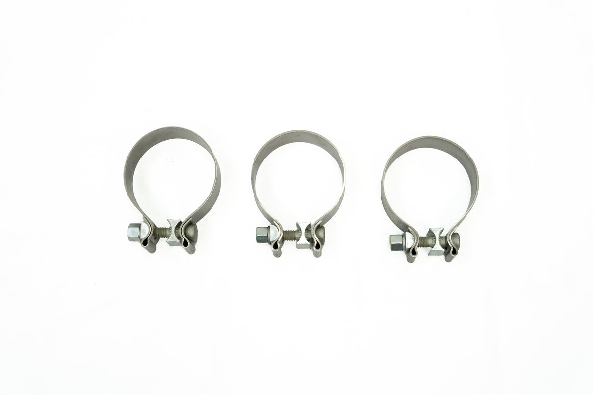 
                  
                    Three metal hose clamps with screw-tightening mechanisms for a performance exhaust system.
                  
                