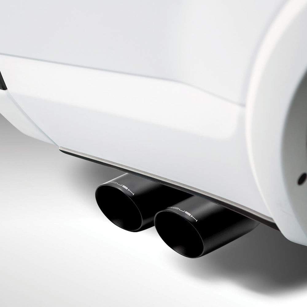 
                  
                    Close-up view of a car's dual black exhaust pipes extending from a white vehicle, showcasing the power and precision of a cat-back exhaust system.
                  
                