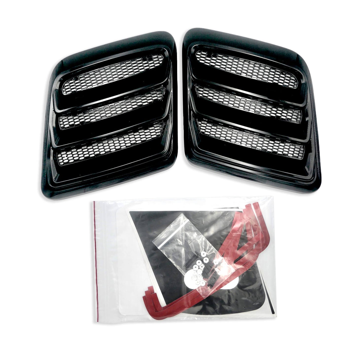 
                  
                    Two gloss black Mustang Hood Heat Extractors with horizontal slats and mesh inserts. Below the vents, there is a clear plastic bag containing red adhesive strips and hardware components from Roush Performance.
                  
                