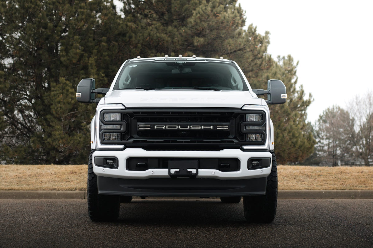
                  
                    Front view of a white 2025 Roush Super Duty parked on a paved road.
                  
                