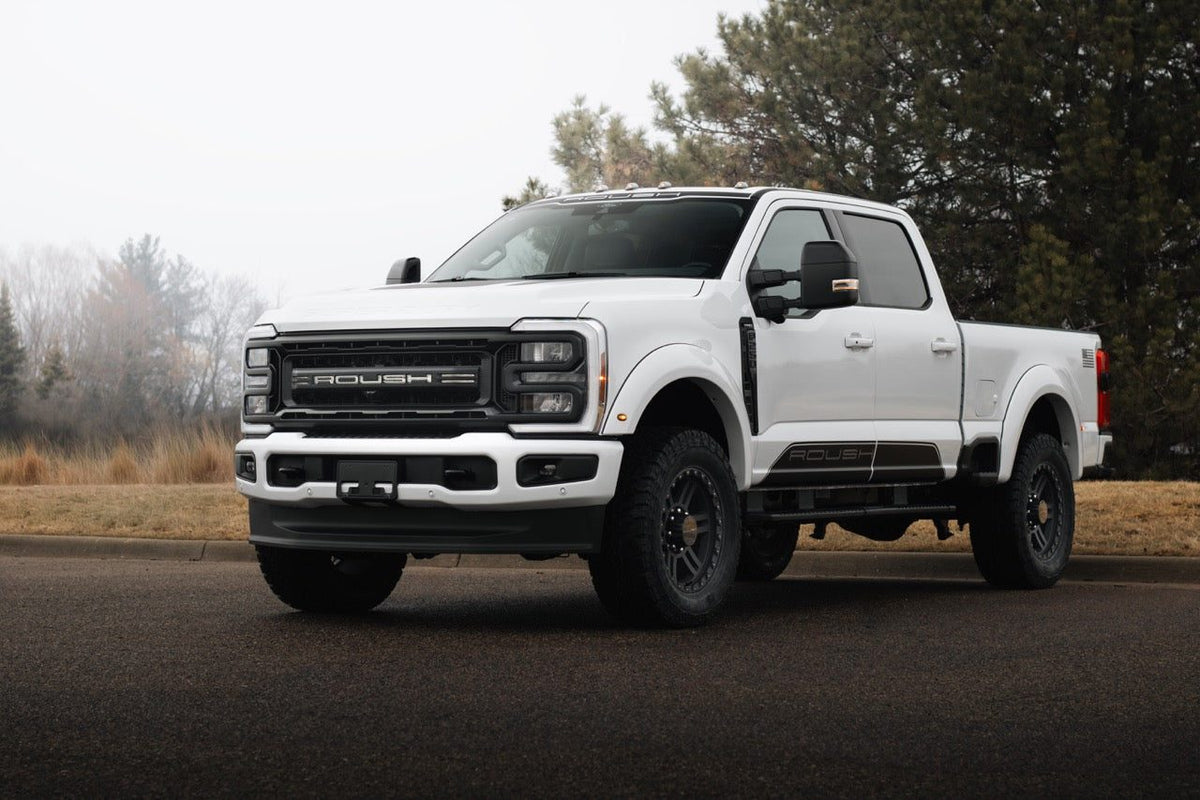 
                  
                    White 2025 Roush Super Duty Ford F-250 truck parked on an asphalt road.
                  
                