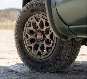Upgraded 17-inch wheels and 265/70 R17 all terrain tires with black lug nuts and exclusive "R" center caps